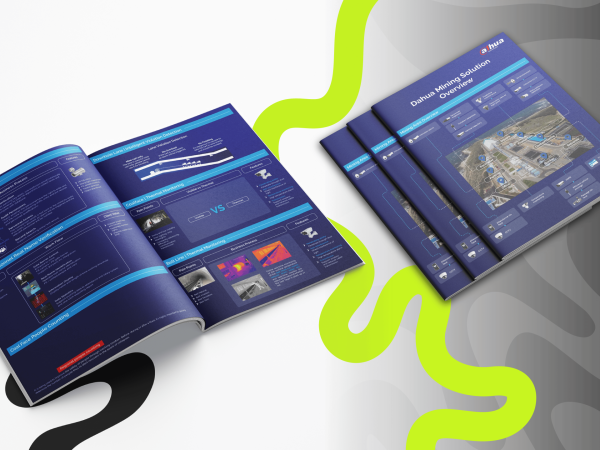 Aerial view of open brochures and closed booklets in a modern style with dark blue covers and technology graphics, against a wavy, abstract background.